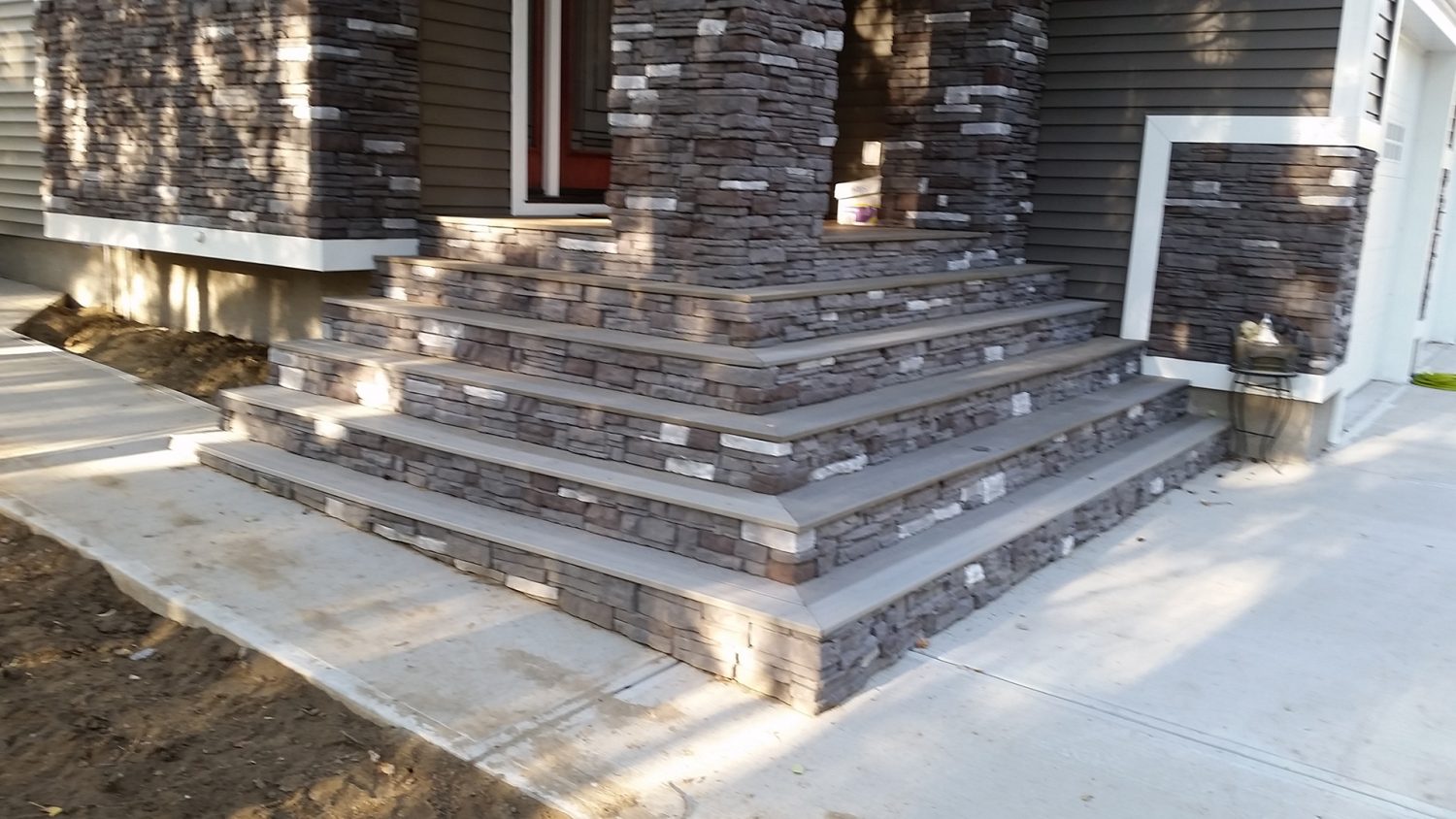 Wrap Around Stairs with Stone Osprey Construction Ltd.
